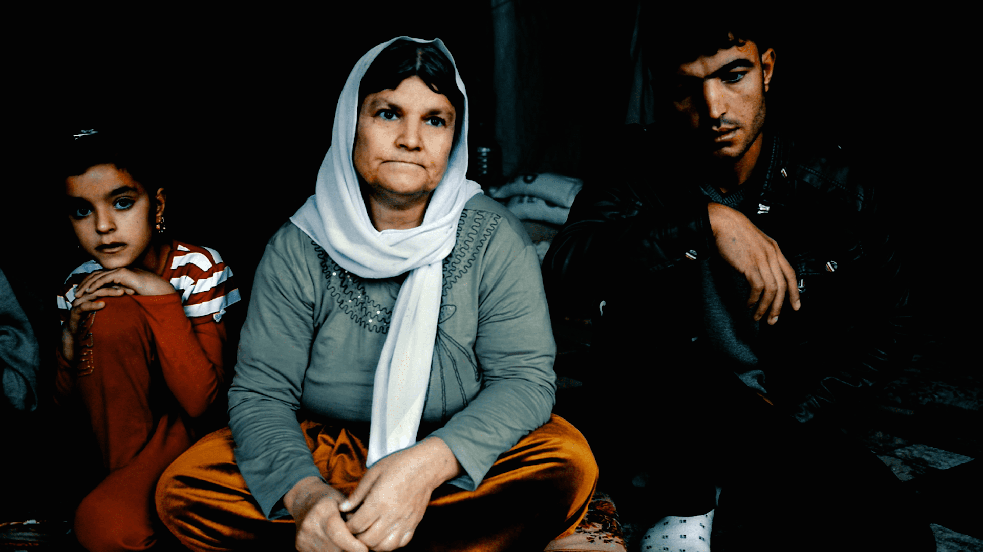 After ISIS overruns the Yazidi heartlands in northwestern Iraq they immediately demand that all Yazidis either convert to Islam or face death. The male members of the Chatto family, who are from the town of Tel Uzeir, refuse and their fate is sealed.